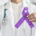 Doctor holding ribbon for cancer awareness