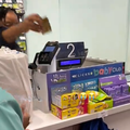 A cashier helps a customer at the checkpoint of a Clicks store