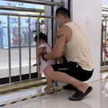 A father helps his daughter get out of the railing