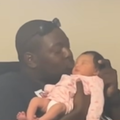 A father kisses his newborn baby girl