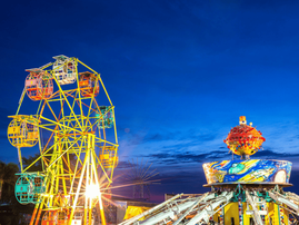 A ferris wheel and gravity machine at amusement park fun fair