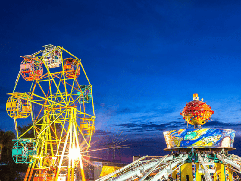A ferris wheel and gravity machine at amusement park fun fair