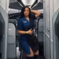 A flight attendant dancing during the aisle of an empty plane
