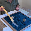 A man playing with a back scratcher on a sequenced material