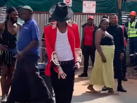 A man who looks like Michael Jackson dances on the streets of Johannesburg