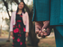 A person holding a diamond ring about to propose