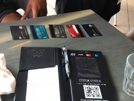 A selection of bank cards laid out on a restaurant table