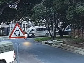 A taxi gets hit by an Aston Martin at a traffic circle