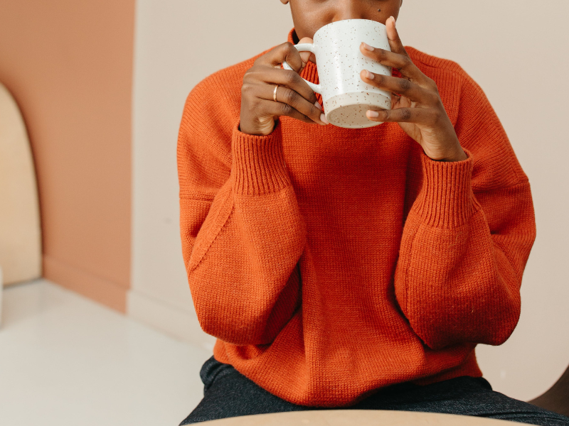 A woman drinking a cup of coffee
