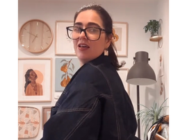 A woman showing off how her jacket is upside down