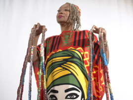 A woman stands showing off the longest nails in the world