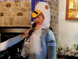 A young boy is wearing a penguin costume
