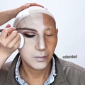 An elderly man gets his makeup done
