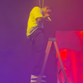 Chris Brown getting off a harness with a ladder during live performance in New Jersey