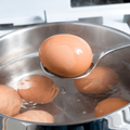 Eggs boiling in a silver pot