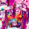 Girls lying in a circle formation after participating in a colour run