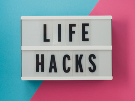 Life Hacks text on display on blue and pink background