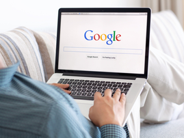 Man sitting on the MacBook on Google search engine