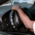Man's hand on a steering wheel