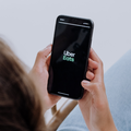 Person using a smartphone with UberEats app open
