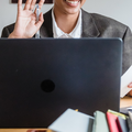 Photo of woman waving during an online business call