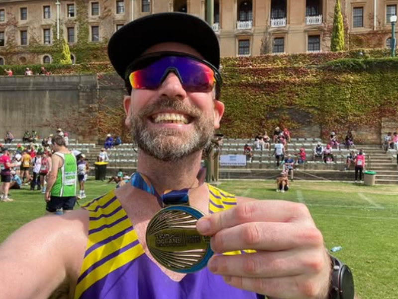 Rory Petzer poses in Cape Town with his Two Oceans Marathon medal