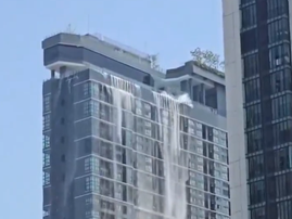 Water cascading off the side of a hotel in Thailand during the earthquake